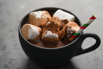 cup of hot chocolate with marshmallow on terrazzo background