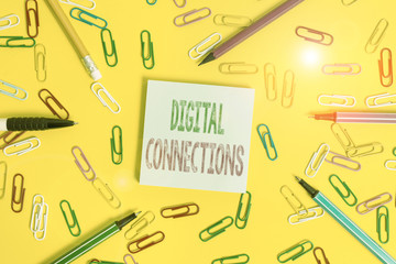 Handwriting text writing Digital Connections. Conceptual photo the online way to explore and build relationships Flat lay above empty paper with copy space pencils and colored paper clips