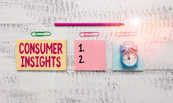 Conceptual hand writing showing Consumer Insights. Concept meaning understanding customers based on their buying behavior Blank notepads marker small alarm clock wooden vintage background