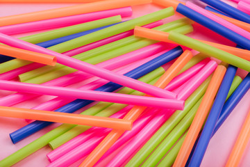 colored tubules for juice and cocktails on pink background. Colorful drink straws. straw, plastic...