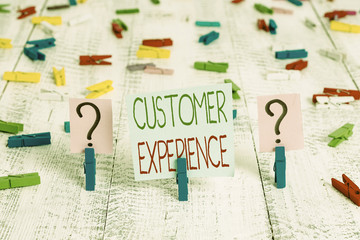 Text sign showing Customer Experience. Business photo showcasing product of an interaction between a client and customer Scribbled and crumbling sheet with paper clips placed on the wooden table