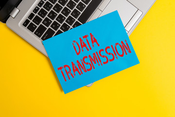 Text sign showing Data Transmission. Business photo showcasing sending data electronically over a communications network Part view trendy metallic laptop clipboard paper sheet colored background
