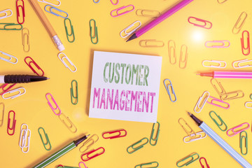 Handwriting text writing Customer Management. Conceptual photo customer retention and ultimately driving sales growth Flat lay above empty paper with copy space pencils and colored paper clips