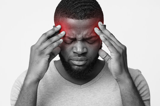 Man Suffering From Headache, Touching His Temples