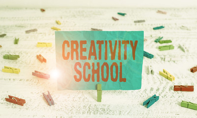 Word writing text Creativity School. Business photo showcasing students are able to use imagination and critical thinking Green clothespin white wood background colored paper reminder office supply