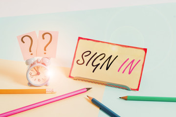 Handwriting text Sign In. Conceptual photo to write your name on a form when entering or leaving a place Mini size alarm clock beside stationary placed tilted on pastel backdrop
