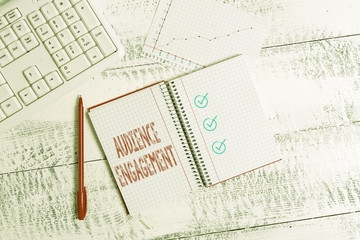 Conceptual hand writing showing Audience Engagement. Concept meaning active involvement of an audience in a live broadcast Papercraft desk square spiral notebook office study supplies