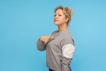This is me! Selfish haughty woman with short curly hair in sweatshirt pointing herself, feeling...