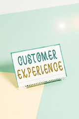Text sign showing Customer Experience. Business photo showcasing product of an interaction between a client and customer Paper placed tilted above buffer wire on soft pastel multi colours backdrop
