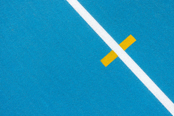 Fototapeta na wymiar Sport background. Blue running track with white lines and yellow mark in sport stadium. Top view