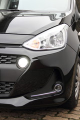 Fototapeta na wymiar a modern car headlight with daytime running lights on a car