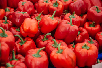 Beautiful selected organic red pepper background, ripe red pepper for preparing meal, lots of red pepper on a market counter.