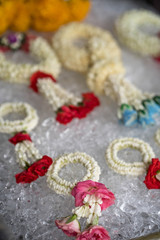 Beautiful garland on ice cubes are for sale at market in Thailand