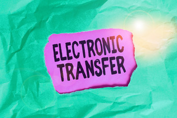 Word writing text Electronic Transfer. Business photo showcasing transaction that takes place over a computerized network Green crumpled ripped colored paper sheet centre torn colorful background
