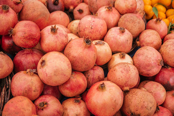 Beautiful selected organic pomegranate background, ripe red an sweet pomegranate, lots of pomegranate on a market counter.