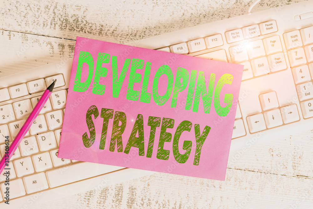 Aufkleber handwriting text writing developing strategy. conceptual photo game plan that sets specific goals an