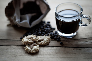 cup coffee, cookie on wooden table.