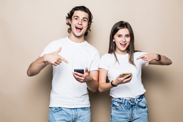 Portrait of attractive couple wearing checked shirt using cell watching smm media subscription...