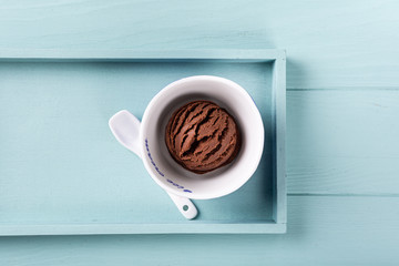 Homemade chocolate ice cream on light blue wooden background. Healthy summer food concept with copy space, top view