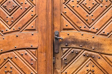 Fototapeta na wymiar Iron handling of a decorated wooden door (Prague, Czech Republic, Europe)