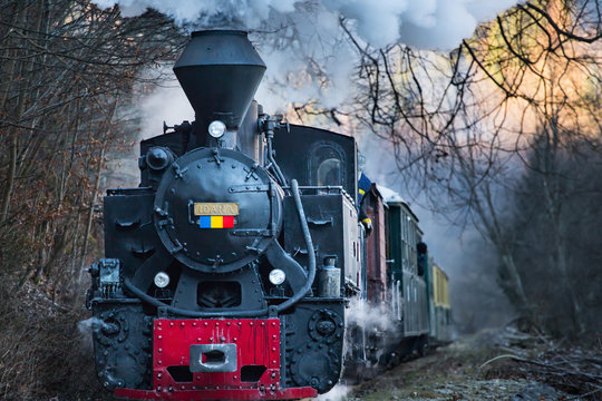 Steam train puffing along the tracks