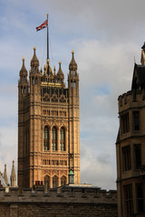 Fototapeta na wymiar British flag waving on top of the Victoria Tower at the Westminster Palace in London, United Kingdom