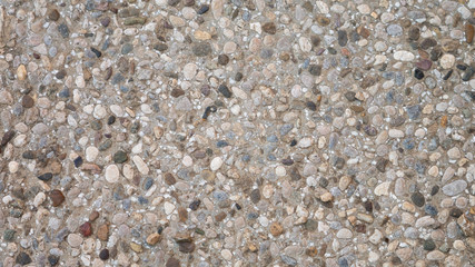 Pebble in concrete path. Top view stone background. 
