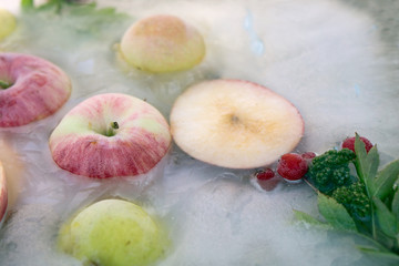 Background fresh season apple    frozen in ice
