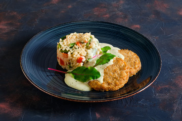 Pike cutlet with rice, green bean and bell pepper with cream sauce