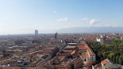 Fototapeta na wymiar Turin, Italy - 01/004/2019: Beautiful panoramic view from Mole Antoneliana to the city of Turin in winter days with clear blue sky and the alps in the background. 