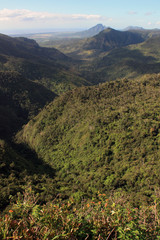 Spectacular view from a viewing point, overlooking the Black River Gorges National Park, Mauritius, towards a waterfall