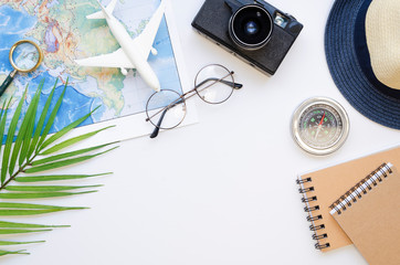 Summer is coming concept top view frame surrounded by a straw hat, palm branches, retro camera and...