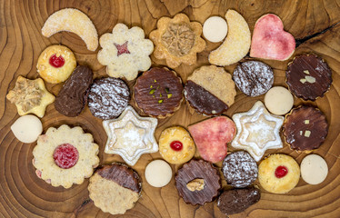 colorful mix of homemade christmas cookies on a wooden board