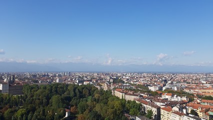 Fototapeta premium Turin, Italy - 01/004/2019: Beautiful panoramic view from Mole Antoneliana to the city of Turin in winter days with clear blue sky and the alps in the background. 