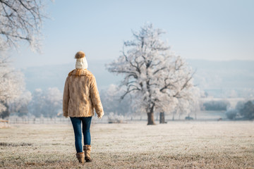Woman walking in winter landscape