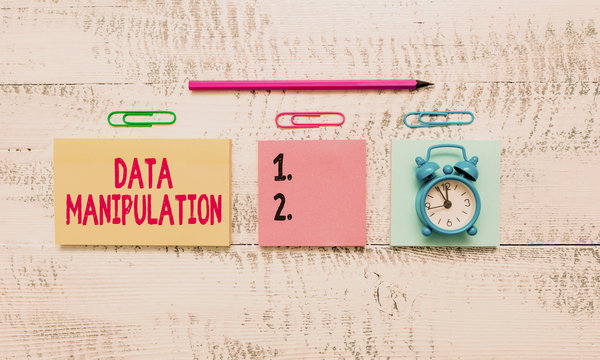 Conceptual hand writing showing Data Manipulation. Concept meaning the process of changing data to make it easier to read Blank notepads marker small alarm clock wooden vintage background