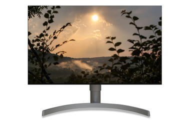 Computer monitor UHD panel with sunset on the background