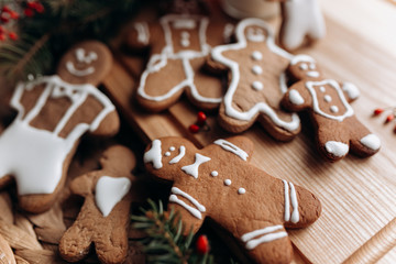 Fototapeta na wymiar painted gingerbread man Christmas gingerbread cookies lie on a wooden board.
