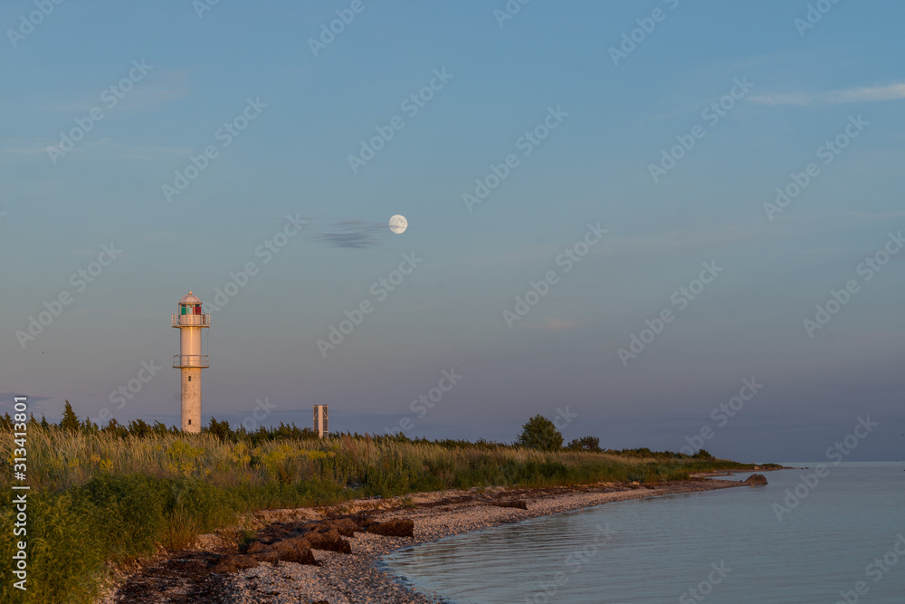 Canvas Prints Skew lighthouse in the Baltic Sea. Shore, evening light, sunset, moon and architecture concept. Harilaid, small island in Estonia, Europe.