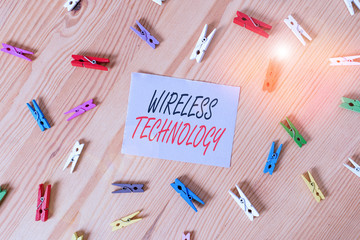 Text sign showing Wireless Technology. Business photo showcasing a technology that allows wireless communication Colored clothespin papers empty reminder wooden floor background office