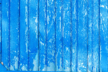 Fototapeta na wymiar Old shabby wooden planks with cracked color paint