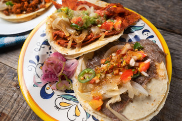 Mexican tacos on wooden background