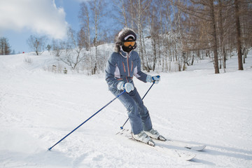 Skiing, skier, winter sport - woman skiing downhill