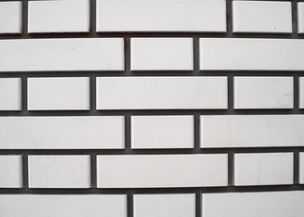Part of the wall is made of white brick masonry. Structure, architecture.