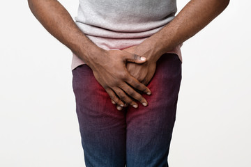 Close up of afro guy covering his crotch with palms
