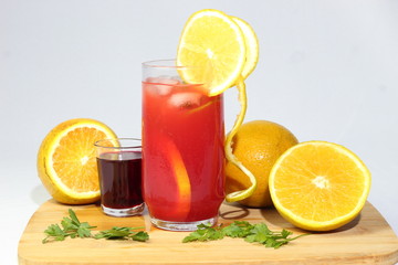 Strawberry juice with orange organic well cold light background