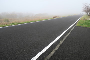Obraz premium 冬の朝霧の江戸川土手のサイクリング道路風景