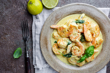 Shrimps in cream sauce with Coconut milk on a plate, top view or view from above, flat lay