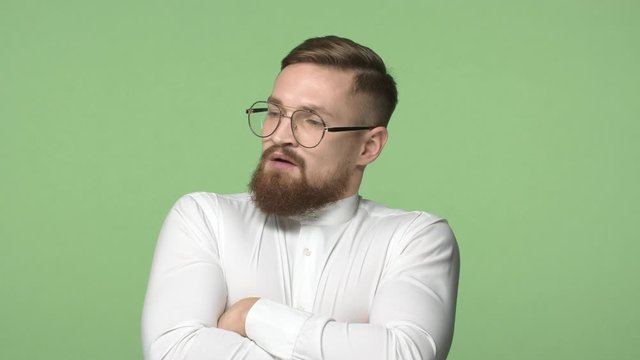 Disappointment, people and team concept. Slow-motion annoyed and upset bearded male, exhale uneasy, shaking head in rejection, disagree, cross hands over chest, look dissatisfied, green background
