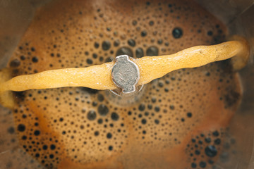 Process of brewing coffee in a moka pot, close-up, top view